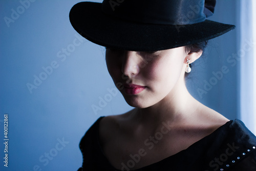 portrait of vintage woman in classic hat and pearls jewelry, retro styling girl