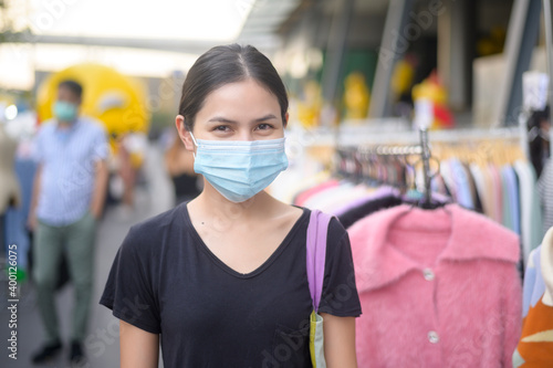 portrait of beautiful woman is wearing face mask in shopping center