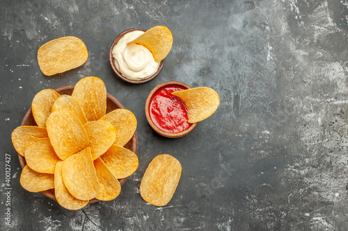 Above view of homemade delicious potato chips mayonnaise with ketchup on gray background stock image
