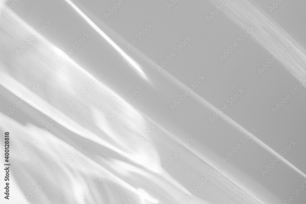 Obraz premium Blurred water texture overlay effect for photo and mockups. Organic drop diagonal shadow and light caustic effect on a white wall. Shadows for natural light effects
