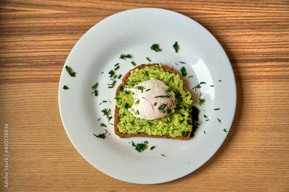 A home made sandwich of avocado and a poached egg. Healthy and healthy food. High quality photo A home made sandwich of avocado and a poached egg. Healthy and healthy food. High quality photo