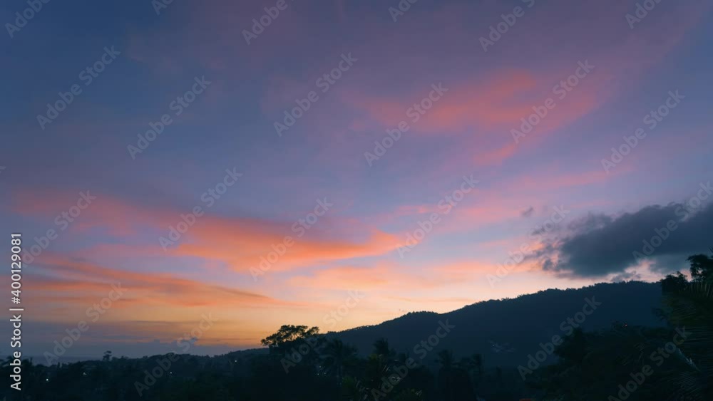 Spectacular sunset over trees and mountains on a tropical island. View from balcony. 4k time-lapse Spectacular sunset over trees and mountains on a tropical island. View from balcony. 4k time-lapse