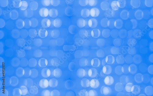 New Year and Christmas holiday concept. Shimmer glitter bokeh wallpaper. Sparkle dark blue rounds. 