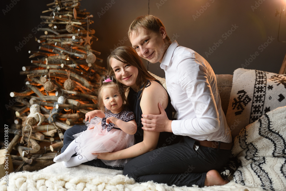 Father mom and their little one year old daughter have fun together before christmas. Father mom and their little one year old daughter have fun together before christmas.