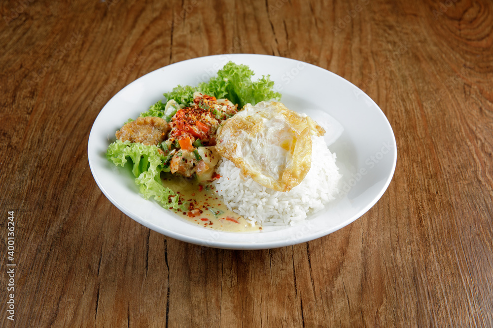 a plate of chicken butter milk with rice a plate of chicken butter milk with rice