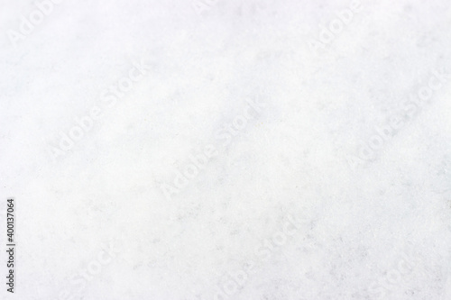 White snow close-up, texture and natural background with copy space