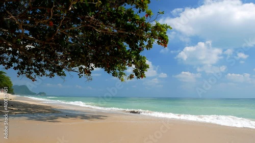 Green tree at the beach side,Sea wave move on white sand with blue sky,Nadan Beach Khanom , Nakhon Si Thammarat Provice ,Thailand 