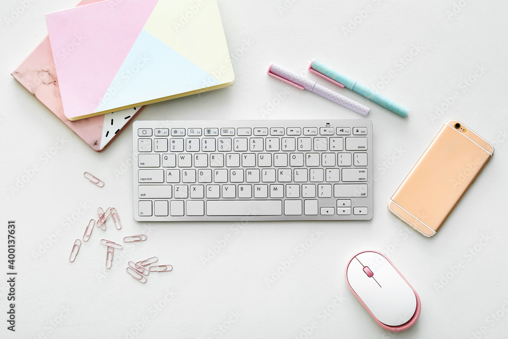 Computer keyboard with mouse, stationery and mobile phone on white background Computer keyboard with mouse, stationery and mobile phone on white background
