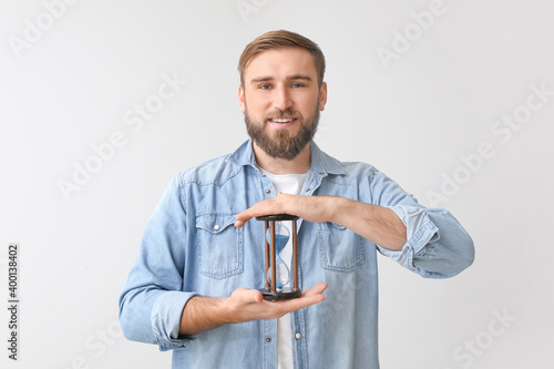 Young man with hourglass on...