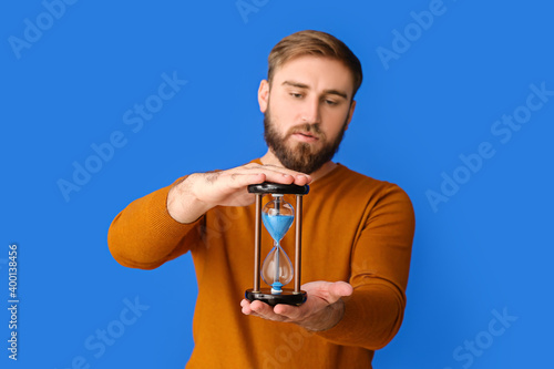 Young man with hourglass on...