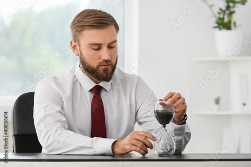 Businessman with hourglass ...