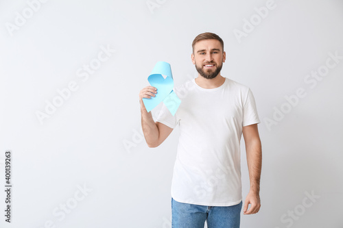 Man with blue ribbon on lig...