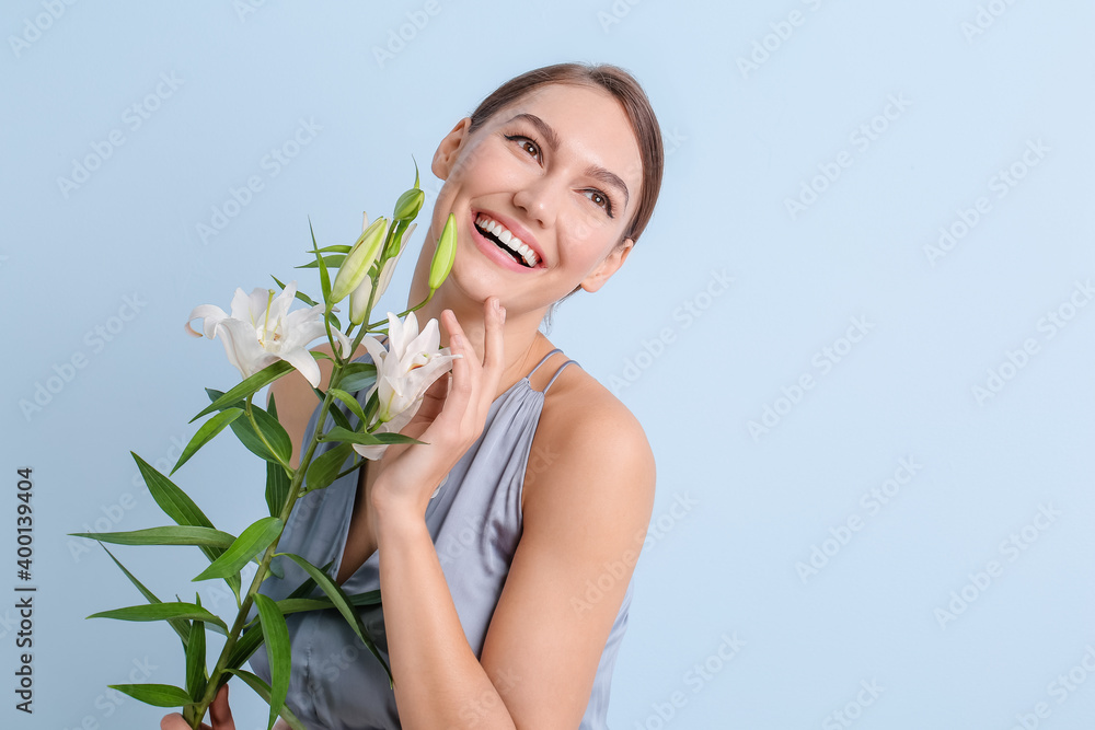 Beautiful young woman with fresh lilies on color background Beautiful young woman with fresh lilies on color background