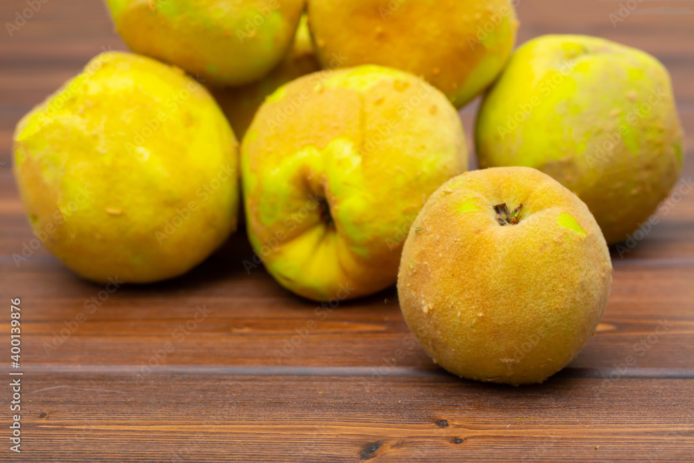 Quince fruit close-up on a wooden background. Quince fruit close-up on a wooden background.