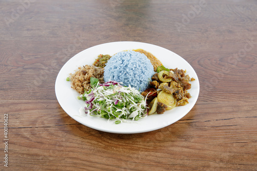 Nasi kerabu or nasi ulam, popular Malay rice dish. Blue color of rice resulting from the petals of butterfly-pea flowers. Traditional Malaysian food, Asian cuisine.