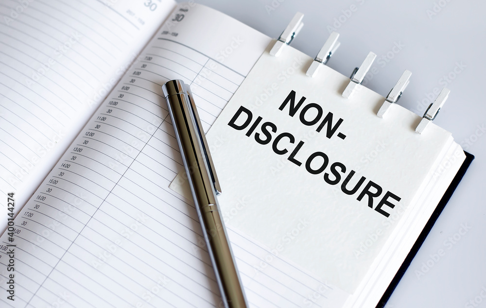 text Non-Disclosure on the short note texture background with pen. Business concept text Non-Disclosure on the short note texture background with pen. Business concept