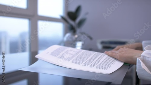 Female hands opens file with documents, looking through, flipping through 
