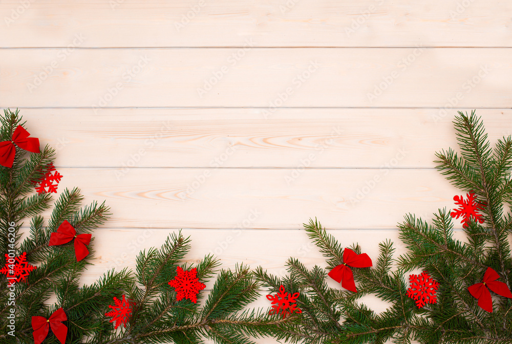 Naklejka premium Christmas tree on a wooden background top view. Festive background for the new year 2021. Elegant card decor for Christmas greetings.