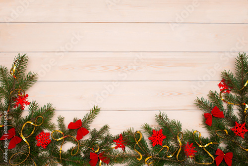 Christmas tree on a wooden background top view. Festive background for the new year 2021. Elegant card decor for Christmas greetings.
