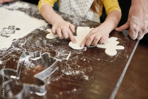 Top view of little girl preparing cookie from dough