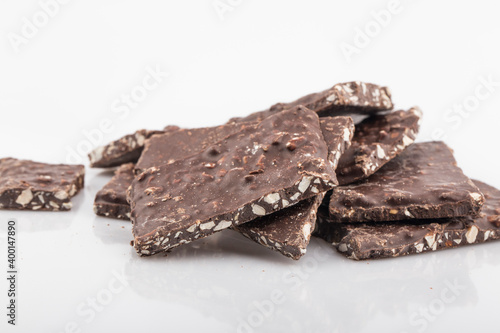 Broken chocolate chips pieces isolated on white background