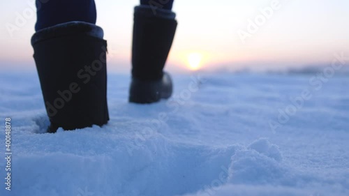 Male feet walking in deep snow. foot steps of hiker. recreational winter activity outdoors. slow motion