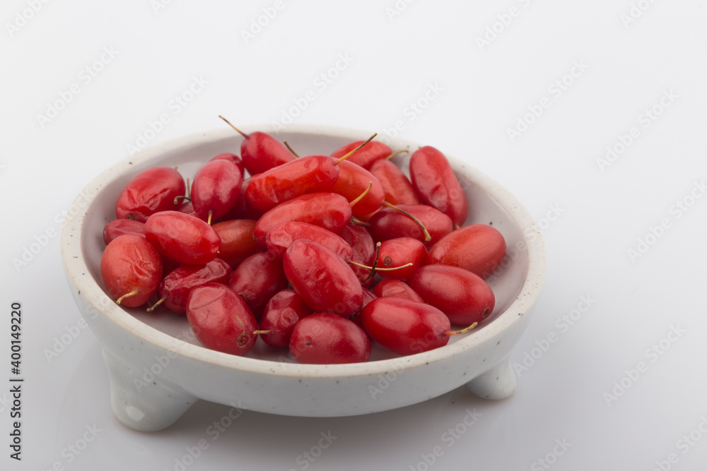 Pile of fresh cornus fruit on a white background. Pile of fresh cornus fruit on a white background.