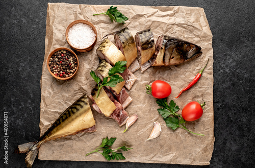 Fototapeta Naklejka Na Ścianę i Meble -  smoked Mackerel with spices and herbs on a stone background