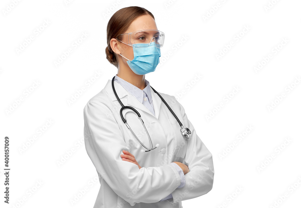 health, medicine and pandemic concept - young female doctor with stethoscope wearing goggles and face protective medical mask for protection from virus disease health, medicine and pandemic concept - young female doctor with stethoscope wearing goggles and face protective medical mask for protection from virus disease