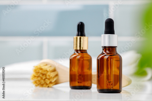 Glass cosmetic oil bottles with pipette in bathroom