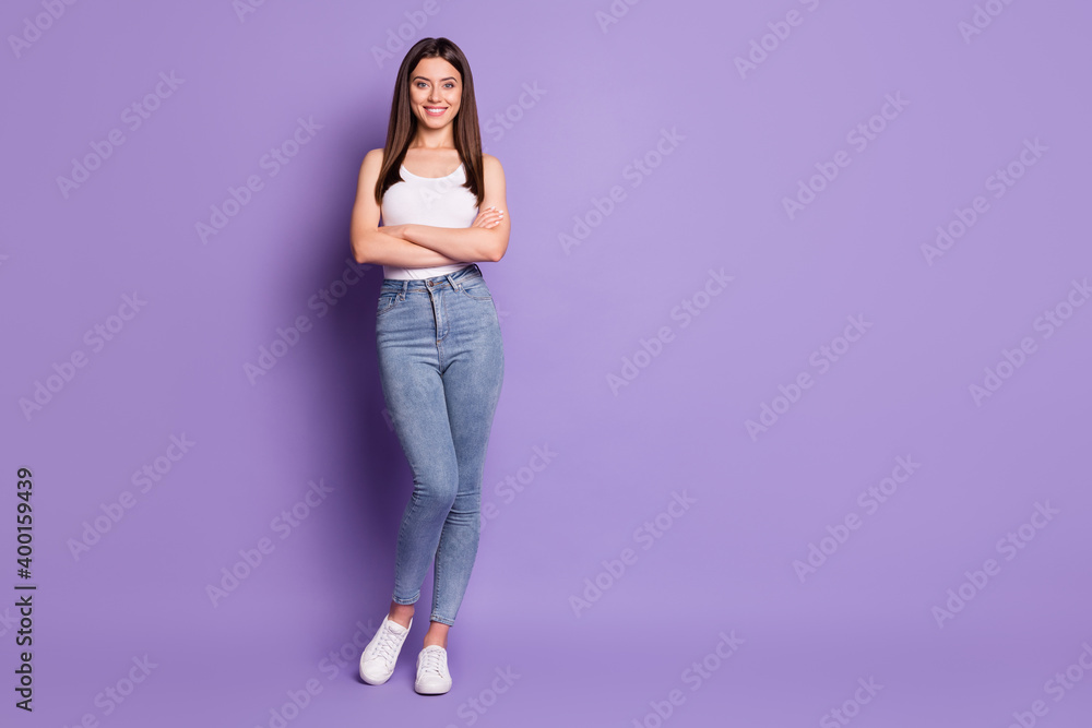 Full length photo of charming confident girl folded hands good mood smile isolated on purple color background Full length photo of charming confident girl folded hands good mood smile isolated on purple color background