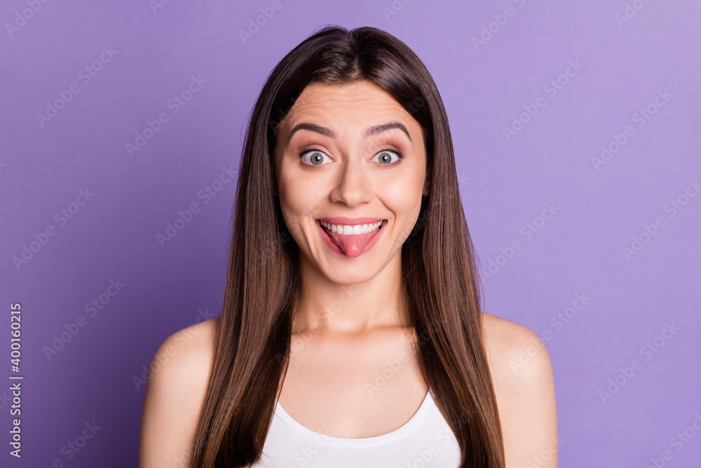 Photo of charming tricky young lady dressed casual white clothes showing tongue isolated purple color background Photo of charming tricky young lady dressed casual white clothes showing tongue isolated purple color background