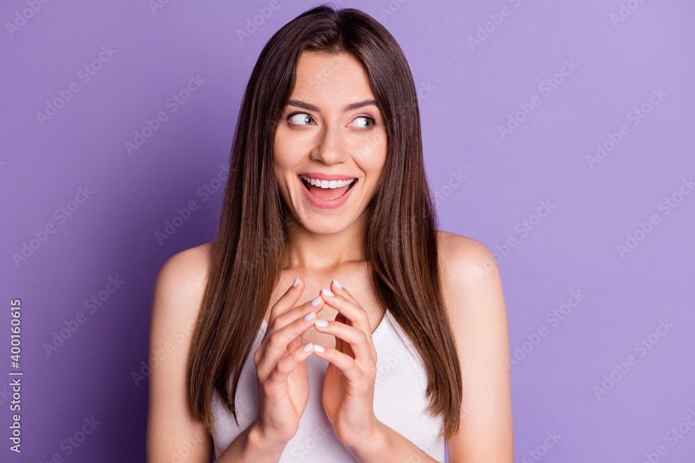 Photo of tricky dreamy young woman wear casual white outfit hands together looking empty space isolated violet color background Photo of tricky dreamy young woman wear casual white outfit hands together looking empty space isolated violet color background