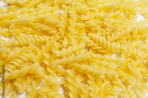 Uncooked raw Italian fusilli pasta on isolated white background.