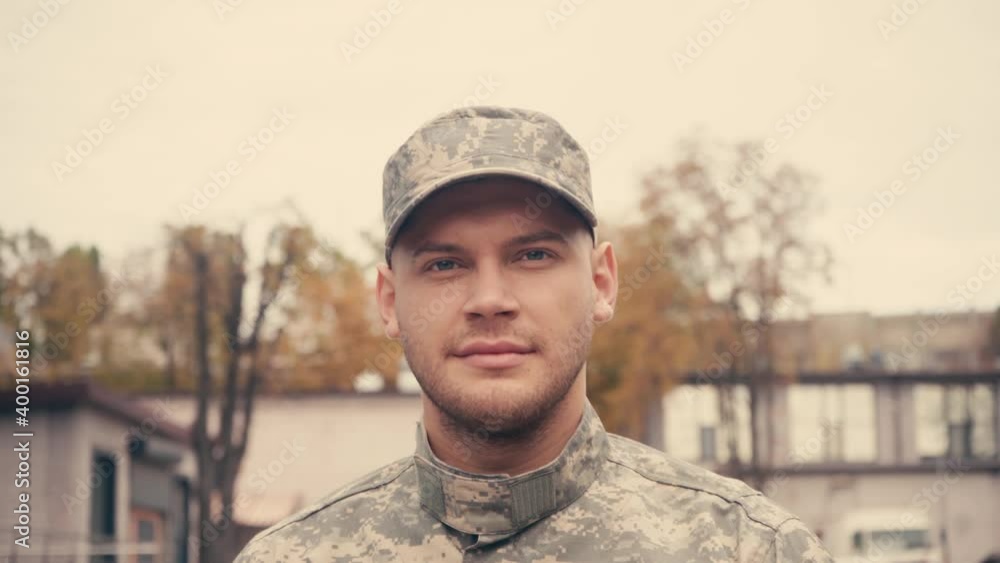 Soldier saluting at camera while walking outdoors Soldier saluting at camera while walking outdoors