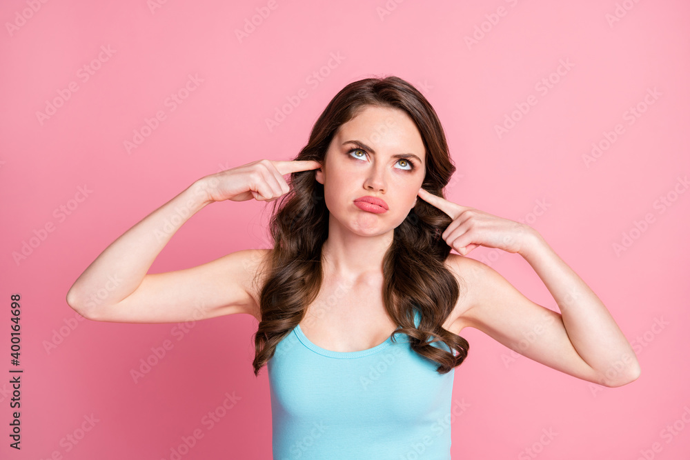 Portrait of ignored upset brunette long hair style girl closed ears pout lips wear blue top isolated on pink color background Portrait of ignored upset brunette long hair style girl closed ears pout lips wear blue top isolated on pink color background