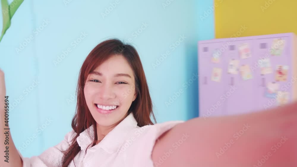 Beauty woman wearing a white shirt with selfie live video to social media spinning around the room Beauty woman wearing a white shirt with selfie live video to social media spinning around the room