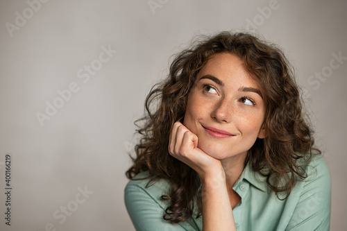 Positive young woman thinking photo