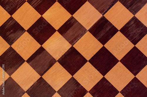 The surface of an old scratched checkerboard.