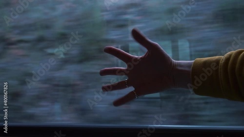 Hand on the background of the road movement in the train carriage on the journey. Artistic installation actionism. photo