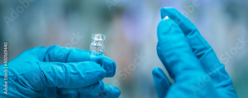 Close up of pharmacist hands with developed vaccine against coronavirus, covid-2019, production and develop of a coronavirus vaccine