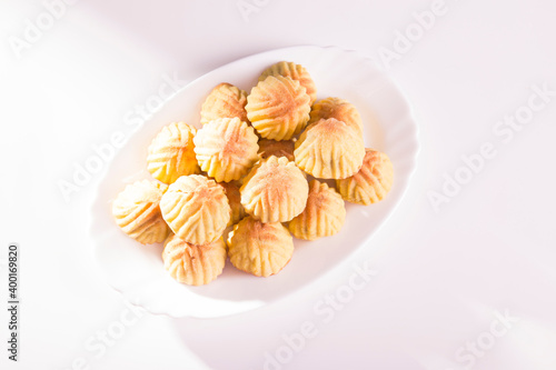 Arabic oriental cookies dates Maamoul in white dish on white background
