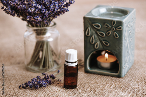 Close up of aroma lamp with burning candle and essential lavender oil, an aromatherapy concept photo