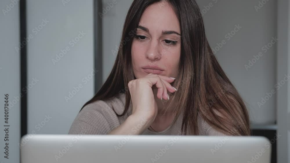 Thoughtful concerned indian woman working on laptop computer looking away thinking solving problem at home office, serious woman search for inspiration make decision feel lack of ideas, close up view Thoughtful concerned indian woman working on laptop computer looking away thinking solving problem at home office, serious woman search for inspiration make decision feel lack of ideas, close up view