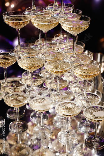 Champagne pyramid for parties at Birthday, party in restaurant. Glasses with champagne in the form of a slide. 2021