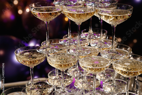 Champagne pyramid for parties at Birthday, party in restaurant. Glasses with champagne in the form of a slide. 2021