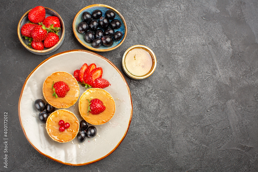 top view yummy pancakes little formed with fruits on grey background pie fruit cake top view yummy pancakes little formed with fruits on grey background pie fruit cake