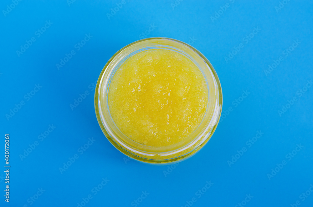 Homemade yellow fruit scrub (bath soak, facial mask) in a small glass jar. Natural beauty treatment and spa recipe. Flat lay, copy space. Homemade yellow fruit scrub (bath soak, facial mask) in a small glass jar. Natural beauty treatment and spa recipe. Flat lay, copy space.
