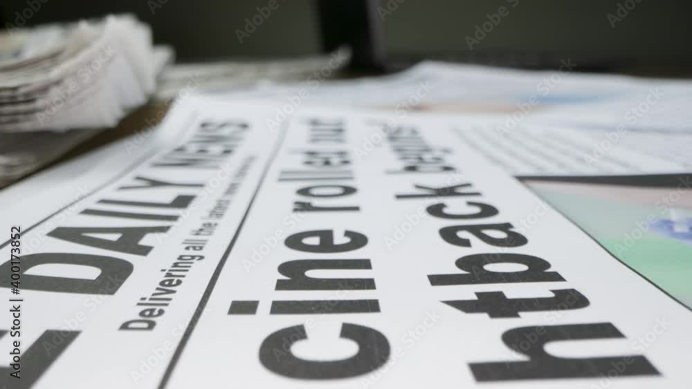 Sliding Extreme Close Up of Pile of Newspapers with Headlines On Covid 19 Vaccines Sliding Extreme Close Up of Pile of Newspapers with Headlines On Covid 19 Vaccines