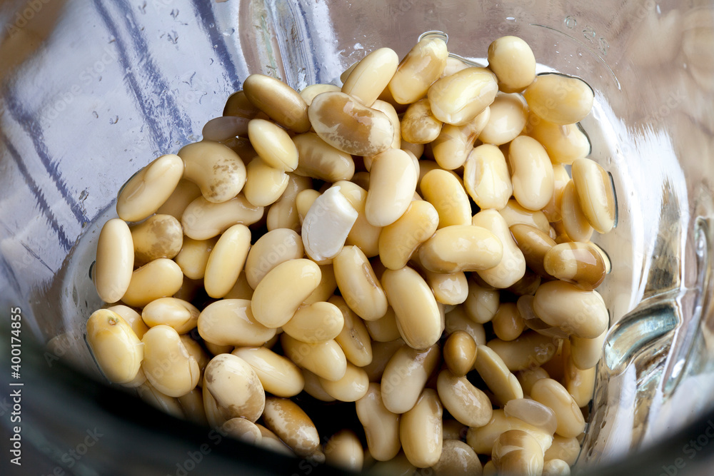 Soybean and water in blender cup. Step by step soymilk preparation at home. Vegan cuisine Soybean and water in blender cup. Step by step soymilk preparation at home. Vegan cuisine
